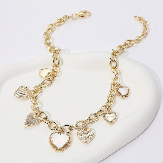 Gold necklace with multi textured heart-shaped charms
