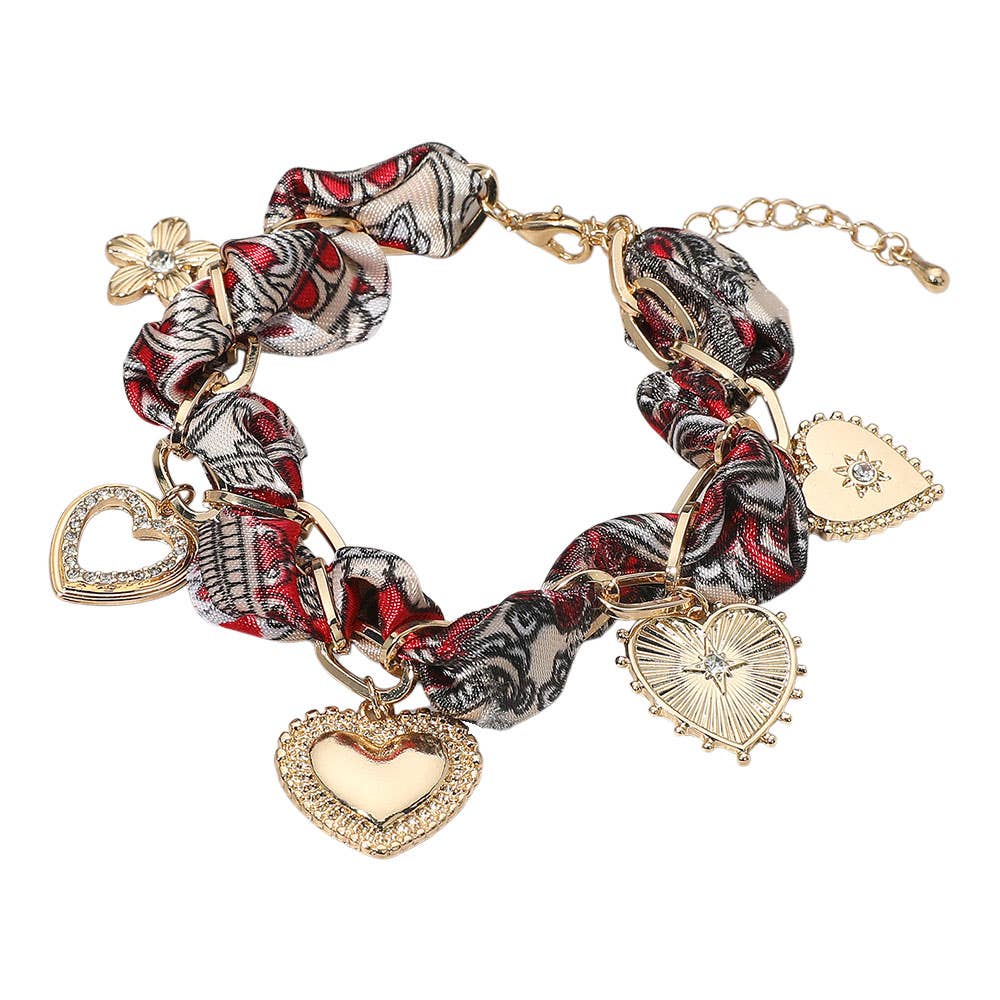 Bracelet with heart-shaped charms and patterned links on a white background