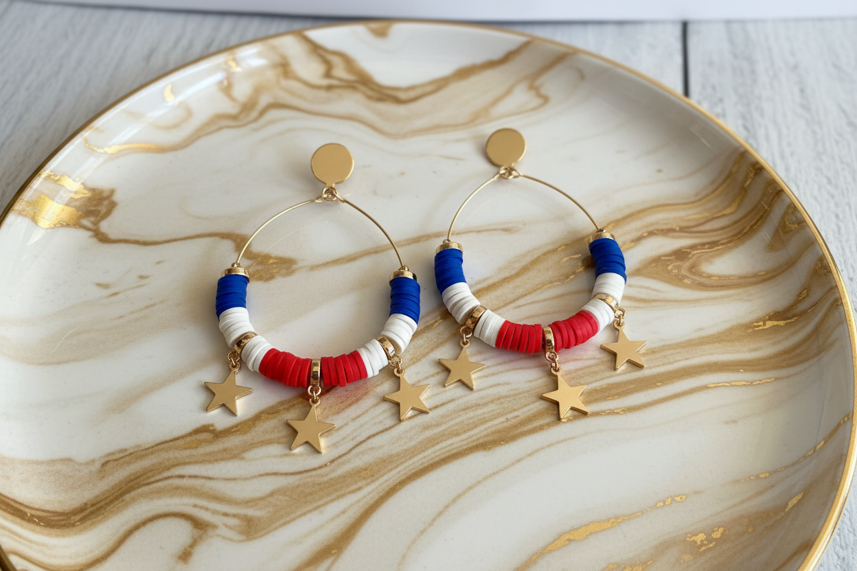 Pair of hoop earrings with red, white, and blue beads on a marbled plate.