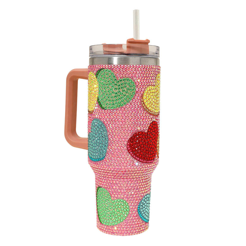 Colorful heart-patterned tumbler with a handle on a white background