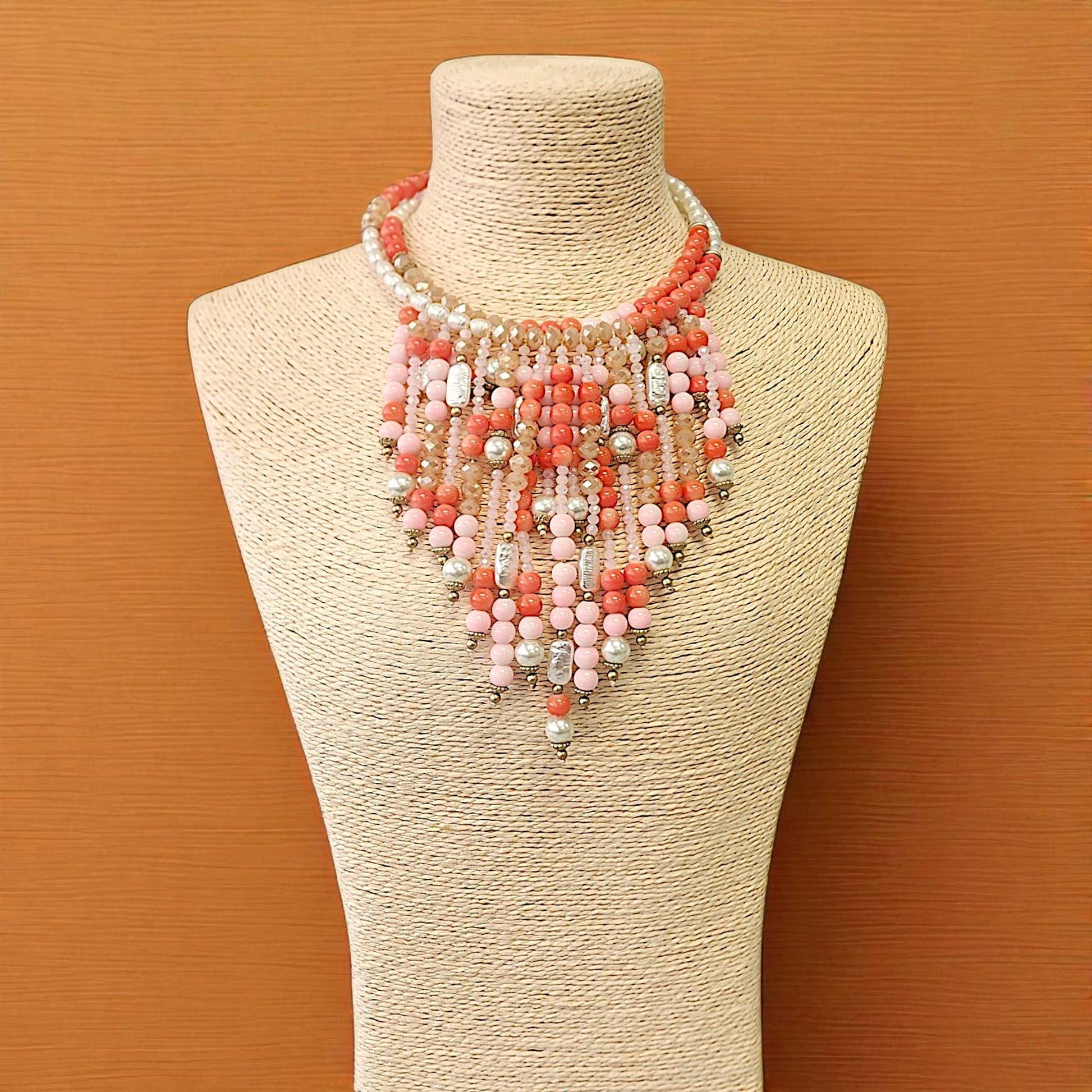 Coral pink boho beaded bib necklace with waterfall fringe and glass beads