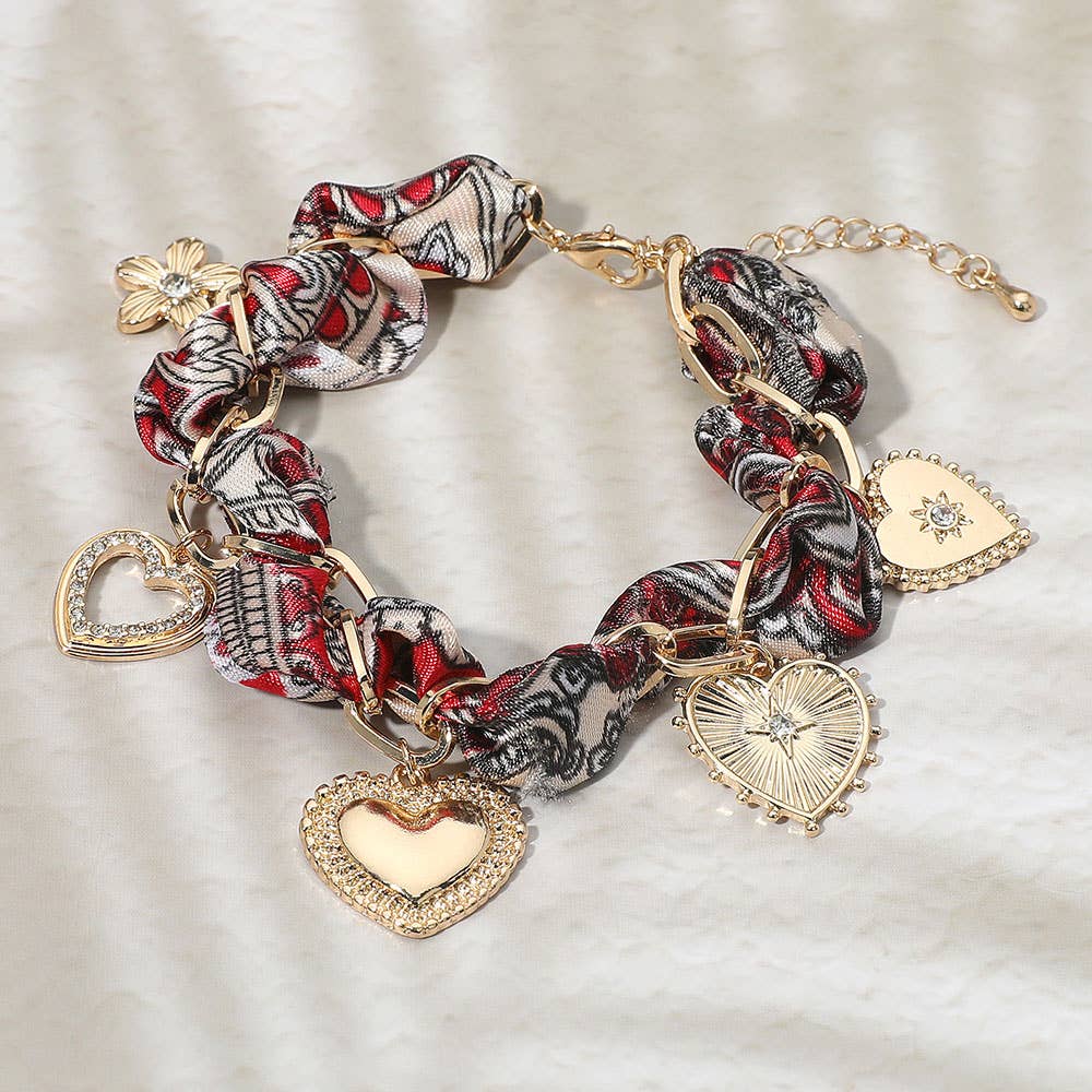Braided fabric bracelet with heart-shaped charms.
