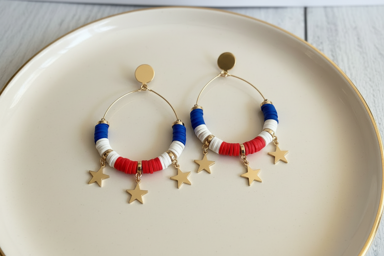 Pair of earrings with red, white, and blue disc beads on a beige plate.